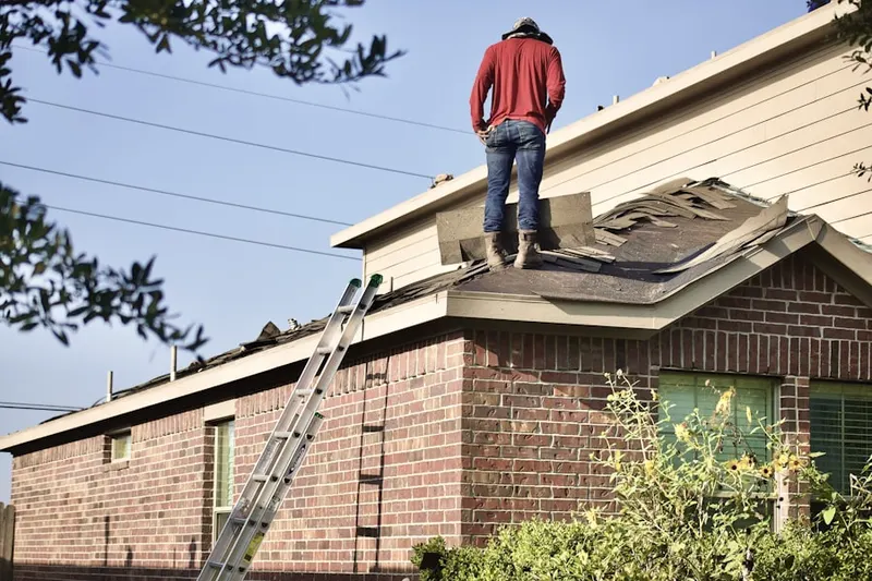 Professional roofer working on a residential roof in Franconia Hunt